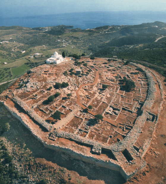 Aerial view of stone ruins and a white church on the hilltop of Agios Andreas, Sifnos