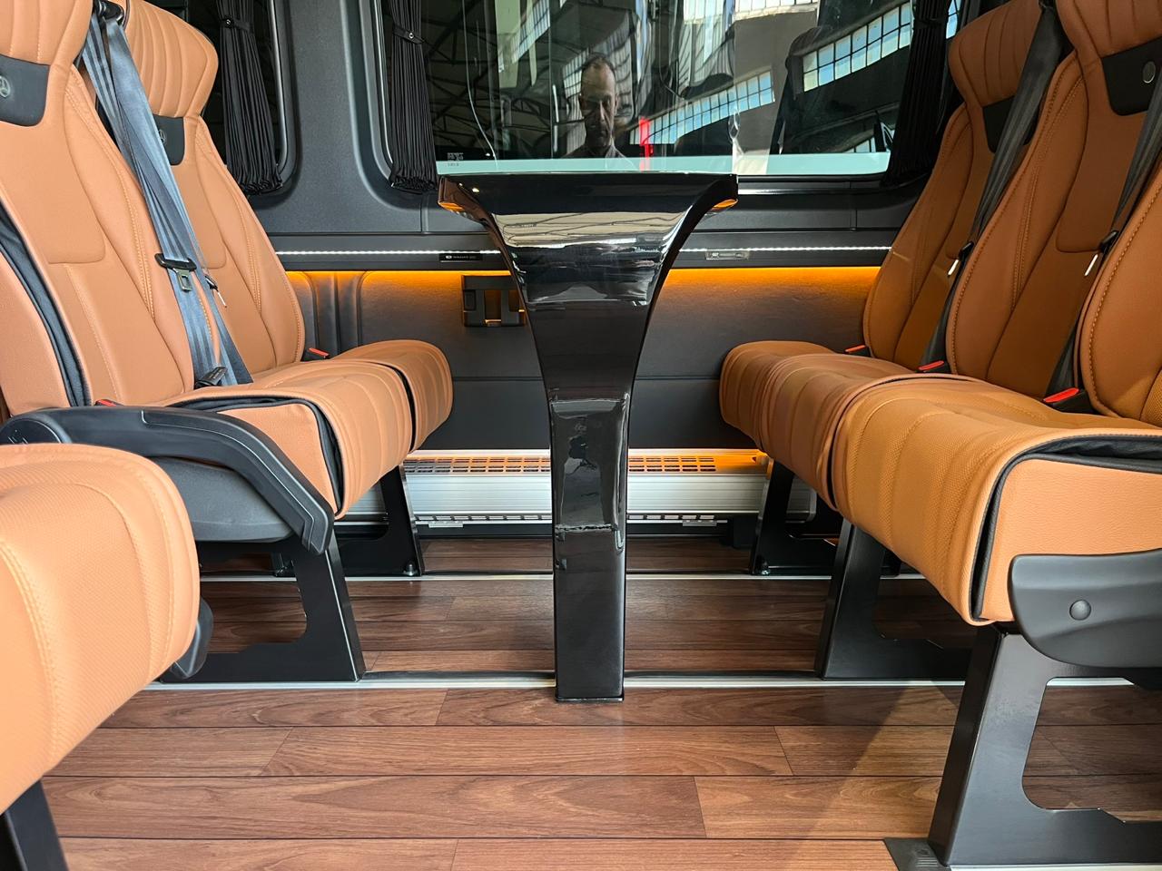 Luxury VIP van interior featuring cognac leather face-to-face seating and executive table for custom bespoke tours in Sifnos